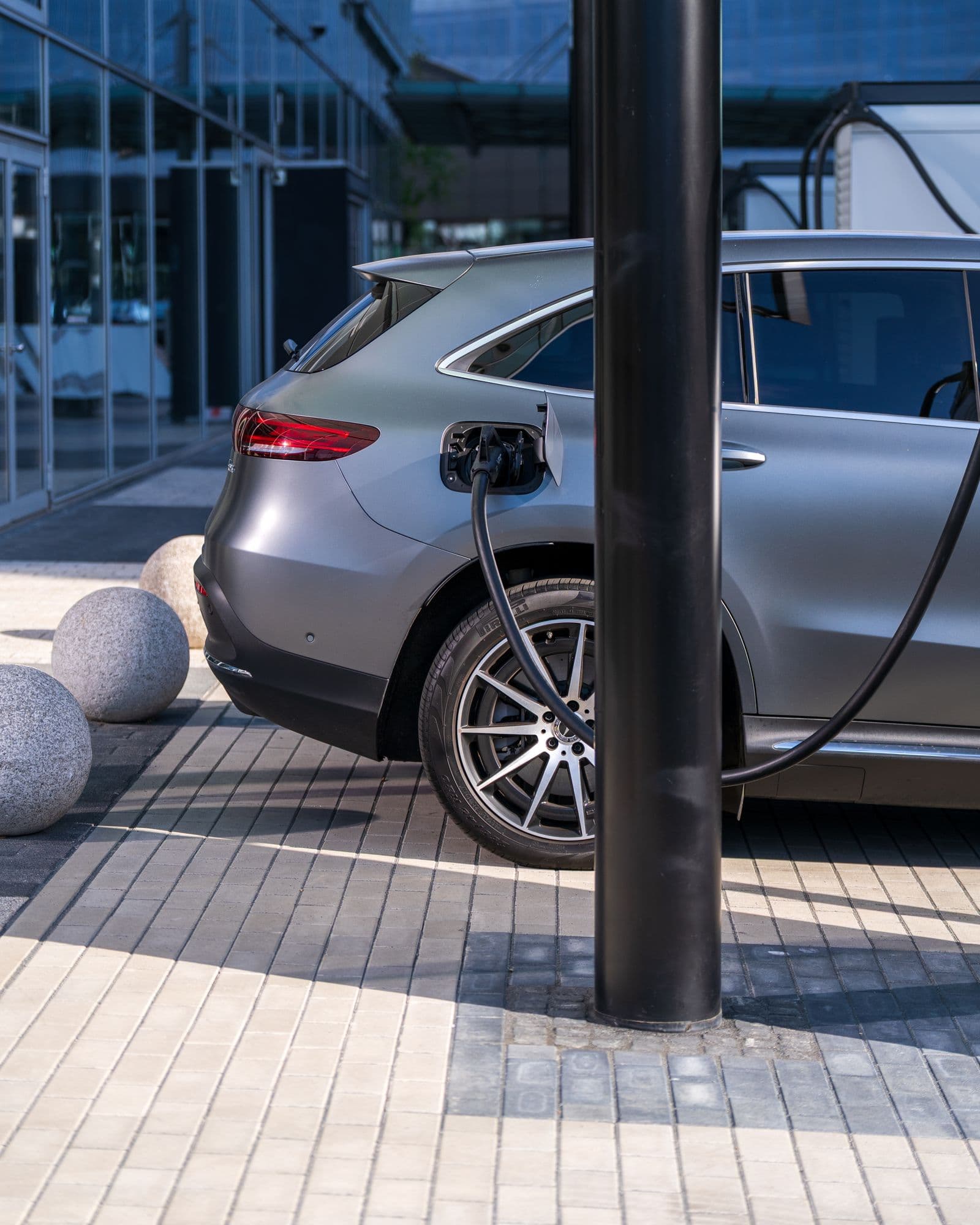 Silver electric car at an urban charging point